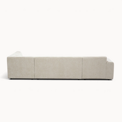 Aika MySofa Nagi U-vormige bank in beige stof, achterkant zichtbaar, modern design met lage poten.