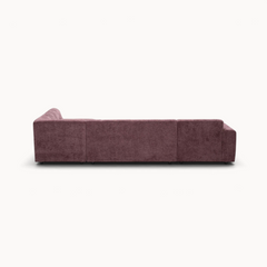 Aika MySofa Nagi U-vormige bank in een diepe paarse kleur met een gestructureerde stoffen bekleding, achteraanzicht.