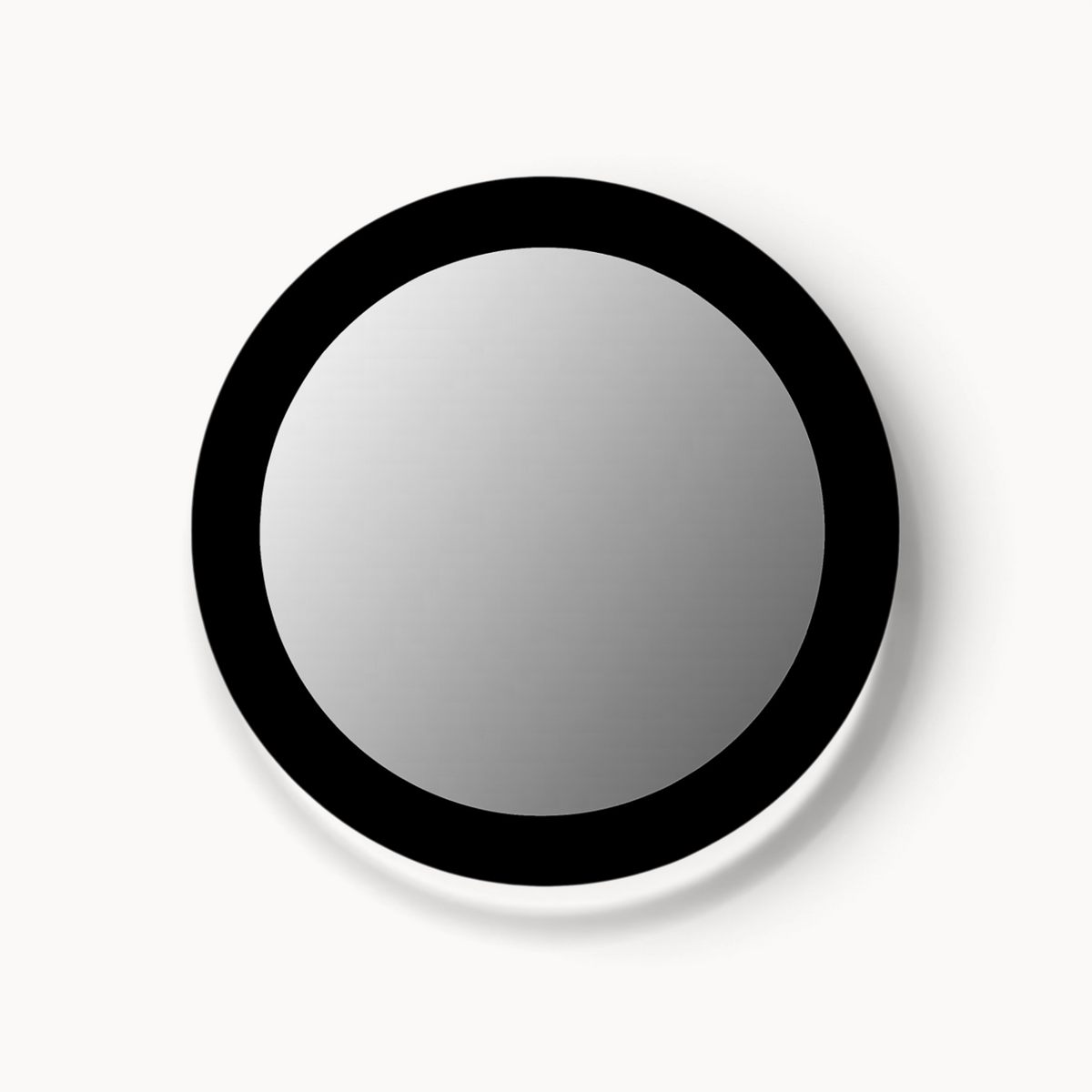 Aika ronde Ensō spiegel met een minimalistisch zwart frame tegen een lichte achtergrond